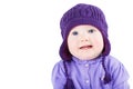 Beautiful baby girl with blue eyes wearing a purple sweater and knitted hat Royalty Free Stock Photo