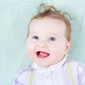 Beautiful baby girl on a green blanket Royalty Free Stock Photo
