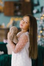 Beautiful baby girl holding a plush Bunny on the background of Christmas lights Royalty Free Stock Photo