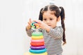 Beautiful baby girl kindergarten playing loop toy education Royalty Free Stock Photo