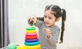 Beautiful baby girl kindergarten playing loop toy education Royalty Free Stock Photo