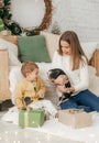 Beautiful baby girl near a Christmas tree with gifts with Royalty Free Stock Photo