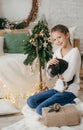 Beautiful baby girl near a Christmas tree with gifts with Royalty Free Stock Photo