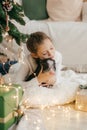 Beautiful baby girl near a Christmas tree with gifts Royalty Free Stock Photo