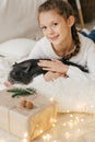 Beautiful baby girl near a Christmas tree with Royalty Free Stock Photo