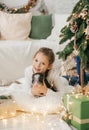 Beautiful baby girl near a Christmas tree with Royalty Free Stock Photo