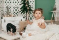 Beautiful baby girl near a Christmas tree with gifts with Royalty Free Stock Photo