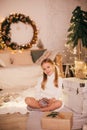 Beautiful baby girl near a Christmas tree with gifts Royalty Free Stock Photo