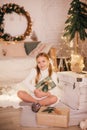 Beautiful baby girl near a Christmas tree with gifts Royalty Free Stock Photo