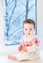 Beautiful baby girl next to window on Christmas day Royalty Free Stock Photo