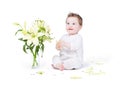 Beautiful baby girl playing with lily flowers Royalty Free Stock Photo