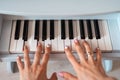 beautiful baby girl playing toy piano in light room Royalty Free Stock Photo