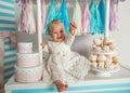 Beautiful baby girl sitting near the fabulous marshmallow house