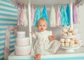 Beautiful baby girl sitting near the fabulous marshmallow house