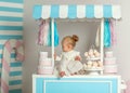 Beautiful baby girl sitting near the fabulous marshmallow house