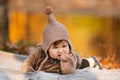 Beautiful baby girl sitting on the plaid near pond. Child outdoor. Baby at picnic in autumn park on sunny day. Pretty little girl Royalty Free Stock Photo