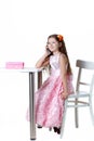 Beautiful baby girl talking on the phone in a dress isolated on a white background Royalty Free Stock Photo