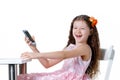 Beautiful baby girl talking on the phone in a dress isolated on a white background Royalty Free Stock Photo