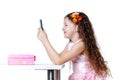 Beautiful baby girl talking on the phone in a dress isolated on a white background Royalty Free Stock Photo