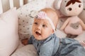 Beautiful baby girl Todler smiles in crib