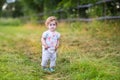 Beautiful baby girl walking on country road at sunset Royalty Free Stock Photo