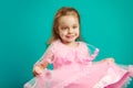 Beautiful baby girl wears pink dress on blue isolated Royalty Free Stock Photo