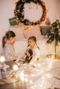 Beautiful baby girls near a Christmas tree with gifts Royalty Free Stock Photo