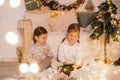 Beautiful baby girls near a Christmas tree with gifts Royalty Free Stock Photo