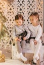 Beautiful baby girls near a Christmas tree with gifts Royalty Free Stock Photo