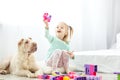 Beautiful baby girls playing with plastic toy blocks. The dog li Royalty Free Stock Photo