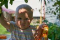 baby in the shadow under a tree,a beautiful baby hid from the heat under a tree, shadows on the face of a surprised girl Royalty Free Stock Photo