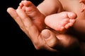 Beautiful baby lies on the hands of the parent handles legs background Royalty Free Stock Photo