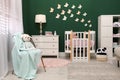 Beautiful baby room interior with stylish furniture and comfortable crib Royalty Free Stock Photo