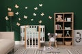 Beautiful baby room interior with stylish furniture and comfortable crib Royalty Free Stock Photo