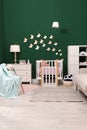 Beautiful baby room interior with stylish furniture and comfortable crib Royalty Free Stock Photo