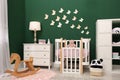 Beautiful baby room interior with furniture and comfortable crib Royalty Free Stock Photo