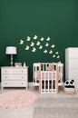 Beautiful baby room interior with furniture and comfortable crib Royalty Free Stock Photo