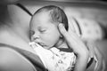 Beautiful baby sleeping in selective foxus, black and white. Close up portrait of newborn sleeping in mother`s hands Royalty Free Stock Photo