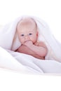 A beautiful baby under a white towel Royalty Free Stock Photo