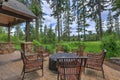 Beautiful back yard stone and brick patio with BBQ grill and luxury futniture Royalty Free Stock Photo