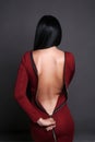 Beautiful back of young woman in a red sexy dress