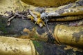 Beautiful background with details of hands of golden buddha damaged with weather