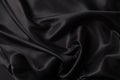 Beautiful background luxury cloth with drapery and wavy folds of black color creased smooth silk satin material texture Royalty Free Stock Photo