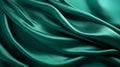 Beautiful background luxury cloth with drapery and wavy folds of green color creased smooth silk satin material texture Royalty Free Stock Photo