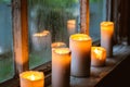 Beautiful background with raindrops on the window and burning candles. Royalty Free Stock Photo