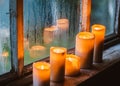 beautiful background with raindrops on the window and burning candles Royalty Free Stock Photo