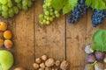 Beautiful background with ripe fruits on old wooden background. Grapes, nuts, figs,plums and apples Royalty Free Stock Photo
