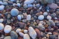 Beautiful background of round, colorful rocks. A peaceful scene from an uncontaminated beach on the ocean.