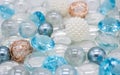 Beautiful background of transparent, light blue glass beads, crystals and white pearls. Copy space Royalty Free Stock Photo