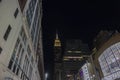 Beautiful backlit view of top of Empire State Building between skyscrapers night. New York City, Manhattan. Royalty Free Stock Photo